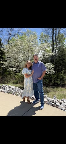 Reviewer wearing the puff-sleeved Ever After Floral Dress while standing with a companion outdoors.