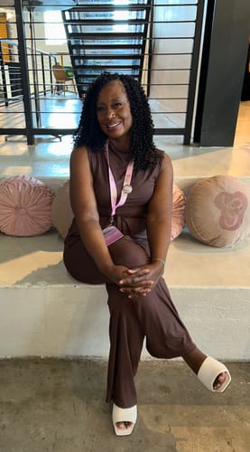 Reviewer sitting on a step wearing the brown Cael Ribbed Mock Neck Jumpsuit.