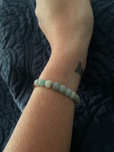 Customer showing a beaded bracelet on their wrist, received as part of a charm order.