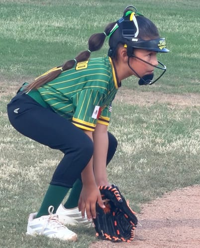 Customer wearing the NEO Softball Fielder's Mask in a ready stance on a softball field.