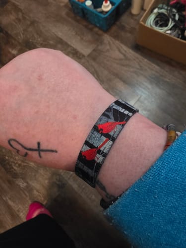 Reviewer's wrist showing the Angels Are Near Bracelet with a red cardinal pattern.