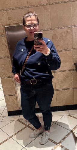 Reviewer wearing the dark blue Sweet Daisy Sweatshirt in a full-length mirror selfie.