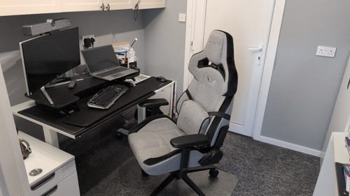 Customer's light grey ZEPHYR Series gaming chair shown in a home office setting next to a desk.