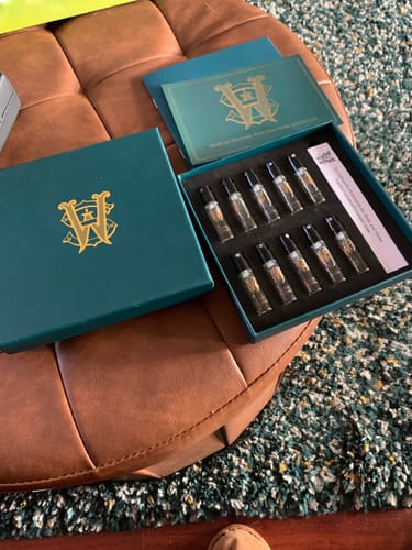 Customer's open Discovery Set, showing ten small perfume sample vials neatly arranged inside the green presentation box.
