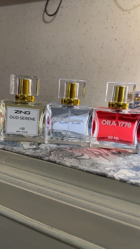 Reviewer's OUD Supreme BUNDLE, showing the three different perfume bottles lined up on a marble surface.