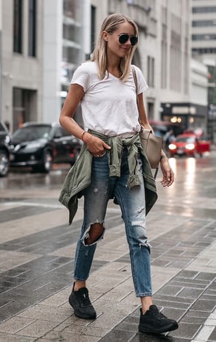 Reviewer walking down a city street in black Ortho Walk sneakers.