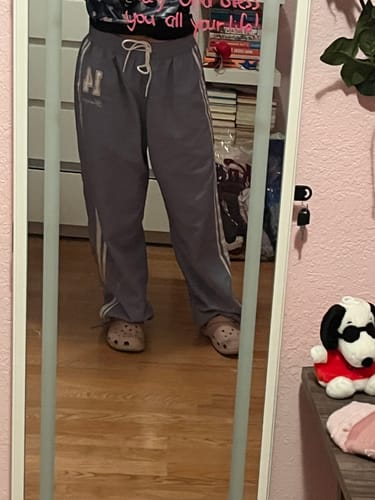 Reviewer showing the long, oversized fit of the grey W280 Weekend Track Pants.