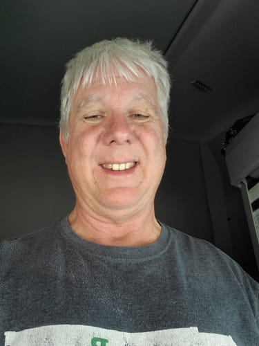 A smiling reviewer in a close-up photo provided for their review.