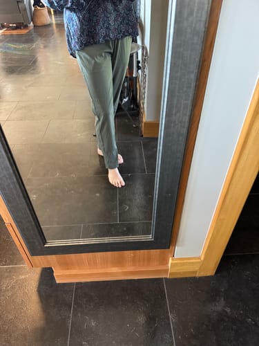 Customer showing the fit of the Nicole Petite Ankle Pant in Sage Olive, ending at the ankle.