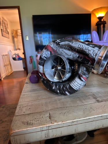 Customer's procharger assembly on a table, showing the 3" V-Band Set connecting the custom-wrapped volute.