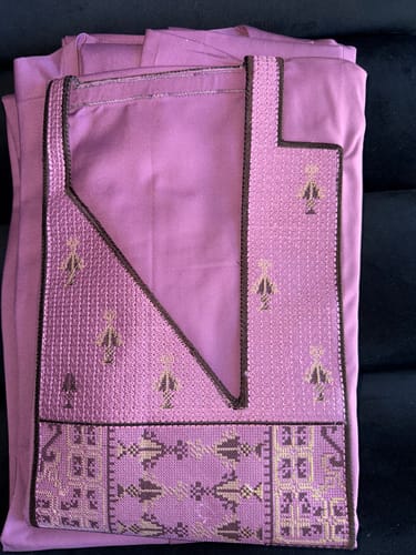 Customer's folded Mauve Embroidered Agbada, highlighting the intricate embroidery on the chest and neckline.