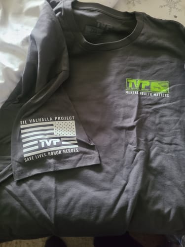 Customer's grey T.V.P. Elite Membership shirt with a 'Mental Health Matters' logo on the chest and an American flag on the sleeve.