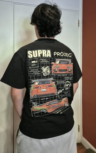 Customer wearing the black Supra Project T-Shirt, showing the detailed graphic on the back.