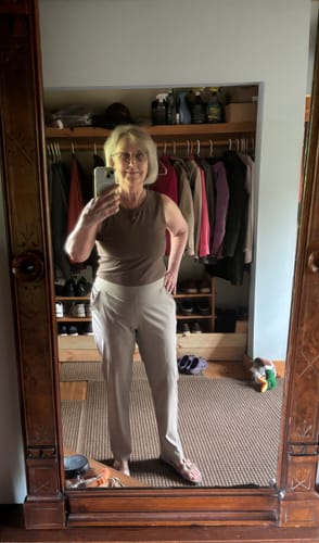 Reviewer in a mirror selfie showing the full-length fit of the khaki Nicole Ankle Pants.