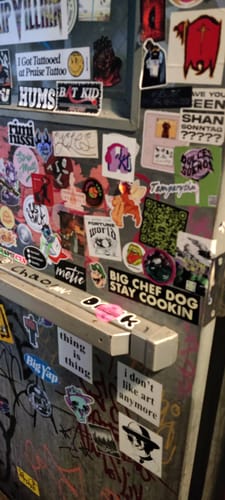 Customer photo of a surface heavily covered with a collage of various stickers.