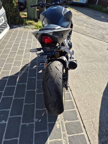 Customer's rear view of a black Honda CB1000 Hornet with the slim tail tidy installed on a paved driveway.