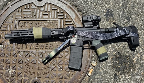 Reviewer's firearm showing Raid Tape used for a custom wrap on the handguard and grip.