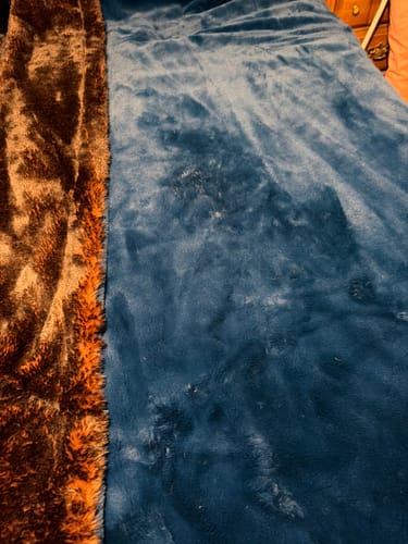 Customer's photo of The Roasted Sea Blanket, showing its two sides: a plush dark blue and a furry brown.