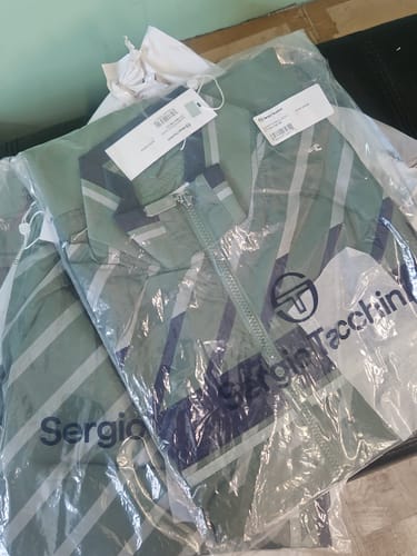 Customer's Quadretto Track Pant and matching jacket shown new and folded in their packaging.