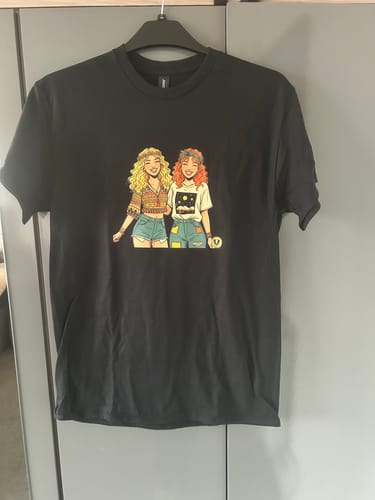 Customer's black unisex t-shirt on a hanger, showing the custom cartoon print on the front.