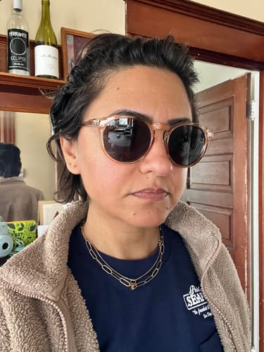 Reviewer wearing the AUSTIN POLARIZED SUNGLASSES with translucent tan frames indoors.