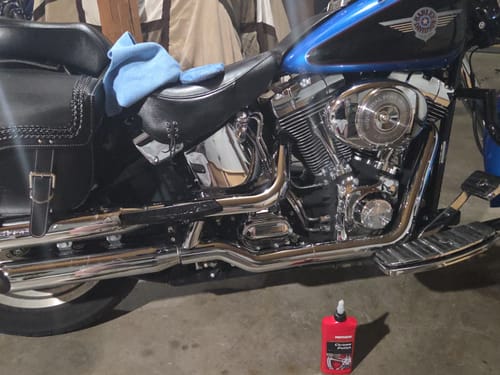 Reviewer's motorcycle showing off its very shiny chrome engine after using Flowgenix Detailing Spray.