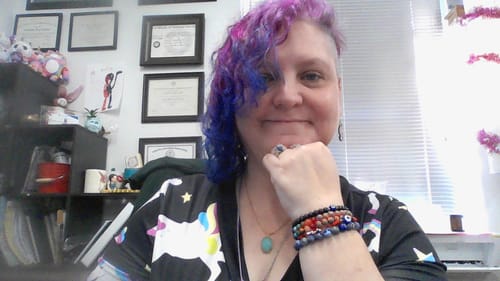 Customer wearing a turquoise necklace and stacked crystal bracelets from the Crystal Comfort Card Deck Offer.