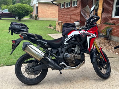 Customer's red and black motorcycle with the Wind Rider Seat Cover installed, showing its perfect fit.