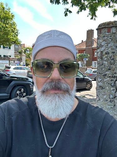 Reviewer wearing the light gray mesh Breathable Brimless Docker Hat outdoors on a sunny day.