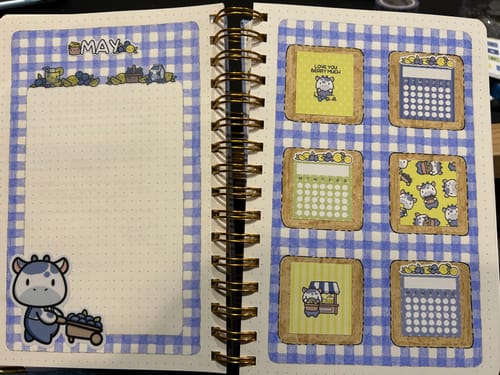 Customer's journal decorated for May with blue gingham paper and cute cow stickers from the Ultimate Subscription.