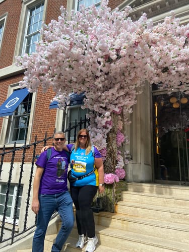 Customers posing on steps in their custom purple and blue unisex t-shirts