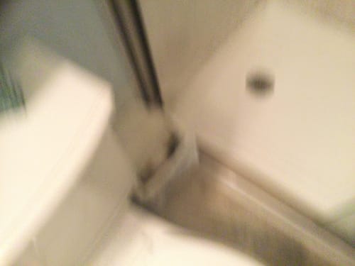 Partial view: Reviewer's blurry photo of the inside of a shower stall.
