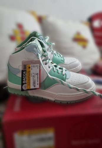 Customer's new Bacca Bucci ETHEREA sneakers in white and sea mint, with the tag still attached, resting on a shoebox.