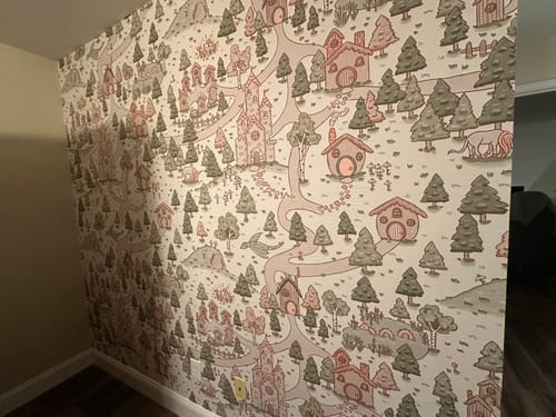 Customer's Adelina Wallpaper installed as a cute accent wall in a nursery corner.