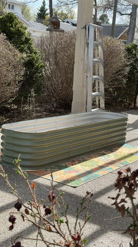 Customer's assembled light green 17” Tall Modular 9 in 1 garden bed in a long rectangular shape, placed on a patio.
