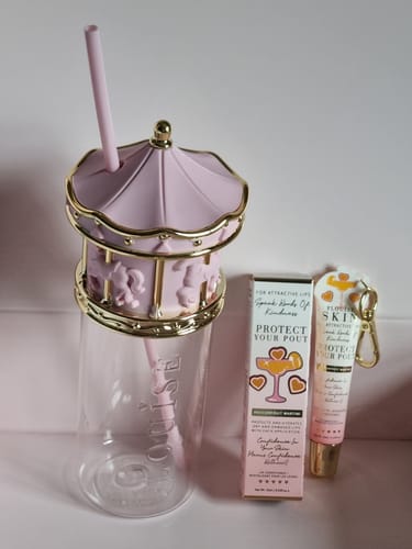 Customer's Sips & Soft Lips bundle with a pink merry-go-round cup and Protect Your Pout lip conditioner.