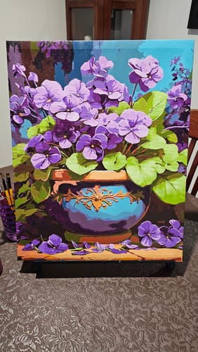 Customer's completed painting from the Vibrant Violets kit, showing purple flowers in a decorative pot.