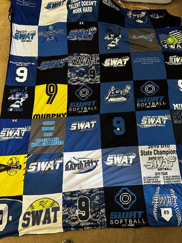 Customer's Premium T Shirt Quilt made from blue, black, and white jerseys from a daughter's softball team.