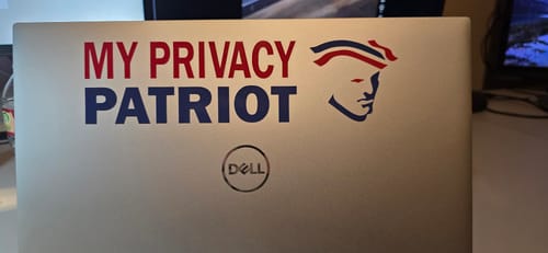 Customer's custom die-cut decal with red and blue 'MY PRIVACY PATRIOT' text and logo, applied to a silver laptop.