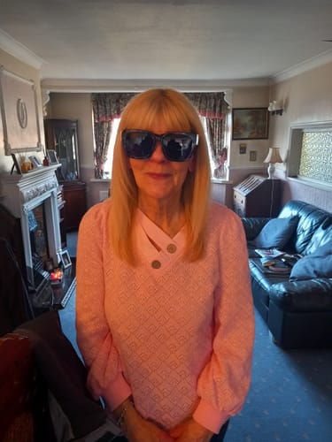 Reviewer wearing the oversized Polarized Fit Over Sunglasses indoors, showing how they look on a person.