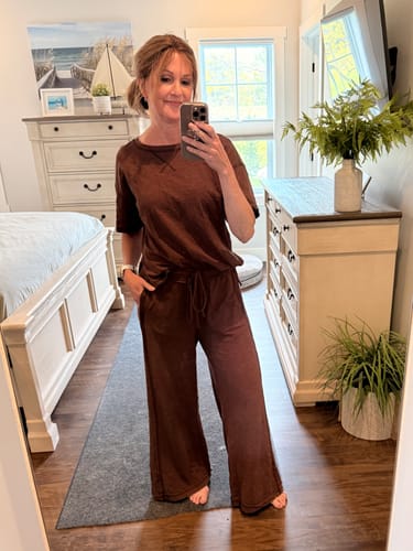 Reviewer showing the relaxed fit of the brown Zen Cotton Slub Lounge Set, with one hand in the pocket.