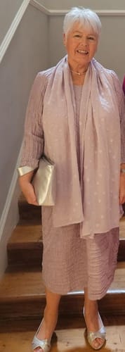 Reviewer wearing the crinkled lilac midi dress with a matching scarf and silver accessories for an event.