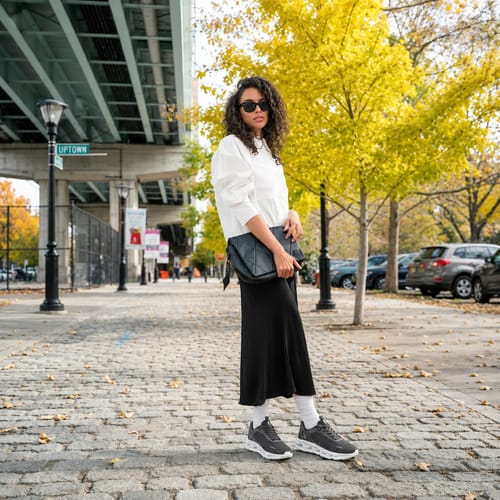 Reviewer wearing the gray Cosmos orthopedic walking shoes on a cobblestone street.