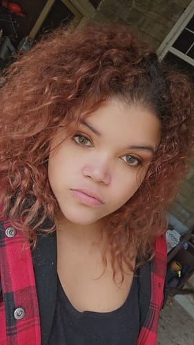 Reviewer wearing Polar Light brown contacts in bright light, making their dark eyes look light and natural.