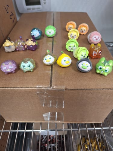 Customer's collection of various colorful Vegetables Fairy Mini Cute Beans figures arranged on a box.