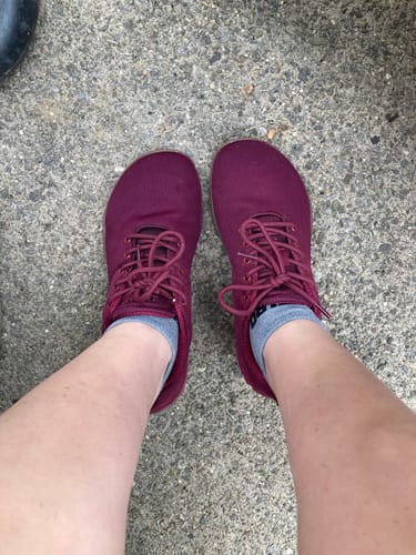 Reviewer wearing magenta Wish I Barefoot Shoes with grey socks, seen from above.