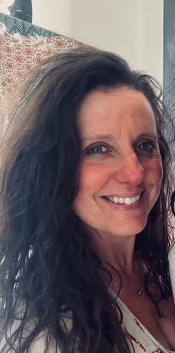 A smiling reviewer shows their clear skin after using F-Balm tallow balm.