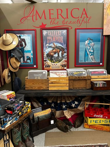 Customer's red America the Beautiful Decal applied to a wall in an antiques booth.