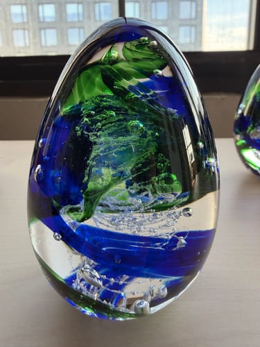 Customer's Glimmer Egg with vibrant blue and green swirls inside, reminiscent of the ocean from the review.