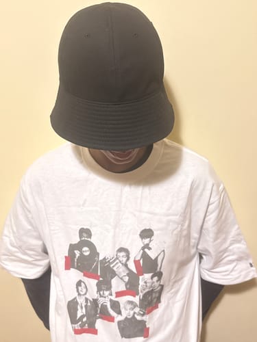 A reviewer wears the deep-fitting black Luoespac Overfit Round Bucket Hat, pulled down to cover their eyes.